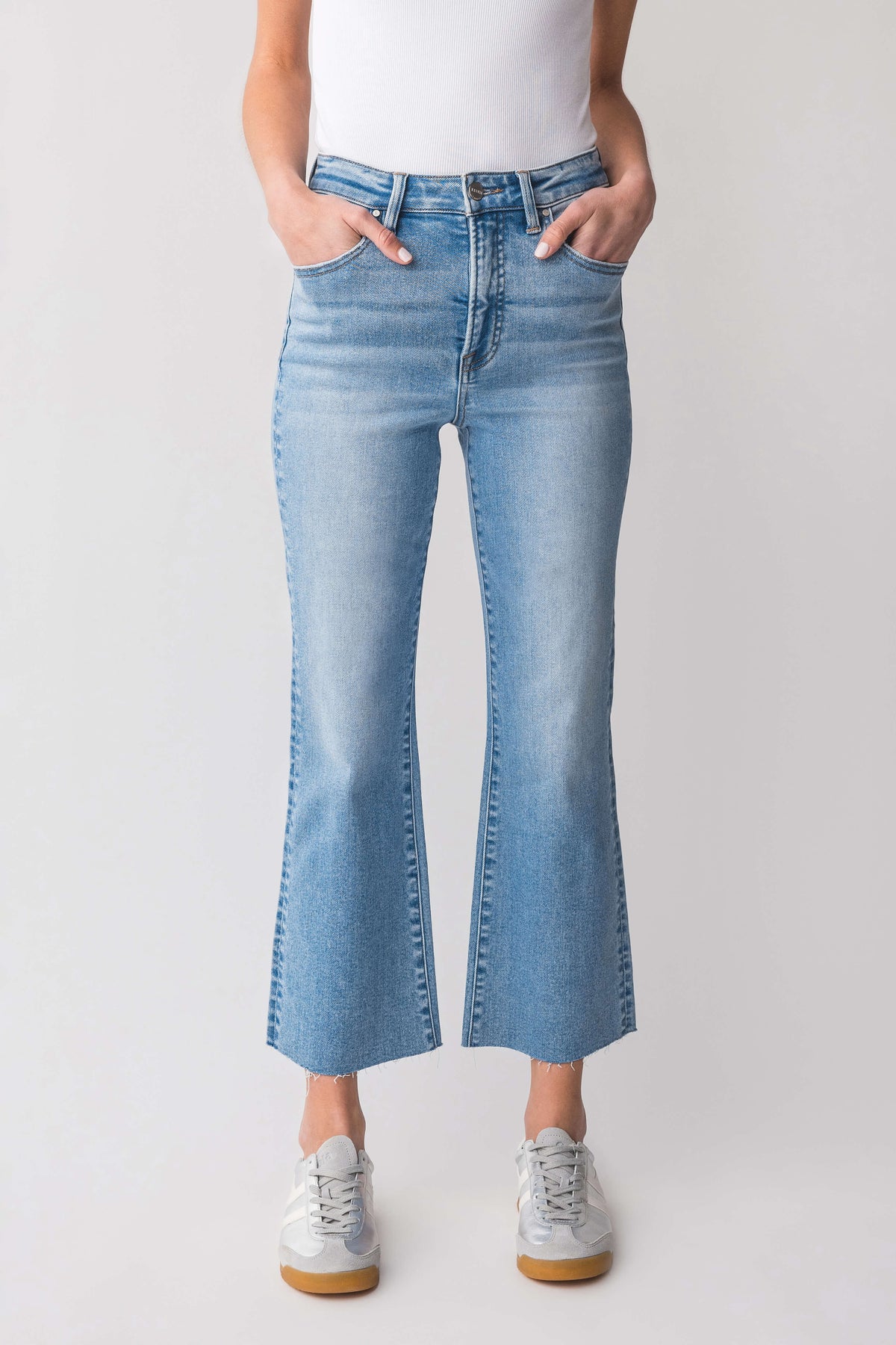 High-rise kick flare jeans in light-wash blue, front view with visible belt loops and seams.