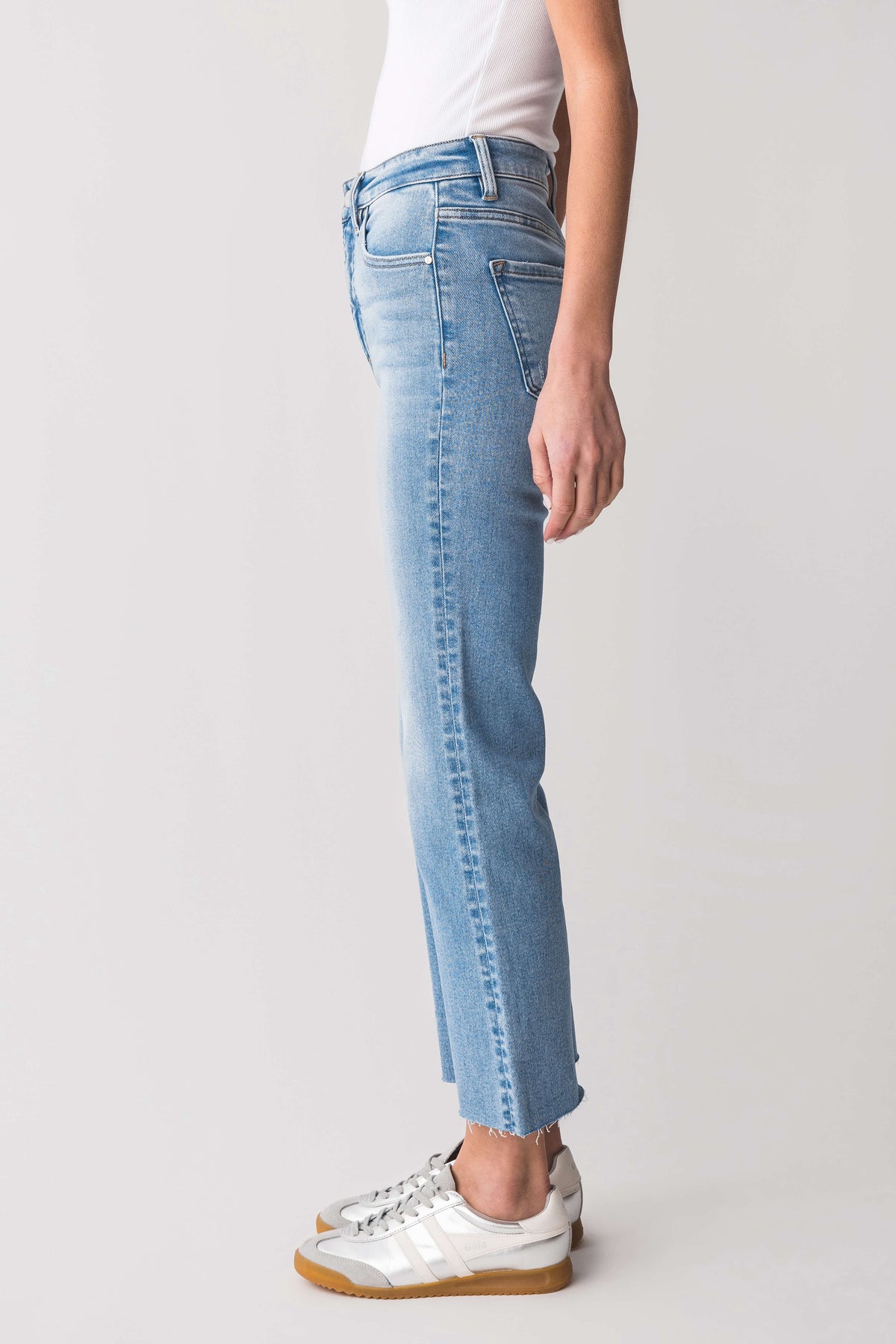High-rise kick flare jeans in light-wash blue, side view with cuffed straight hems.