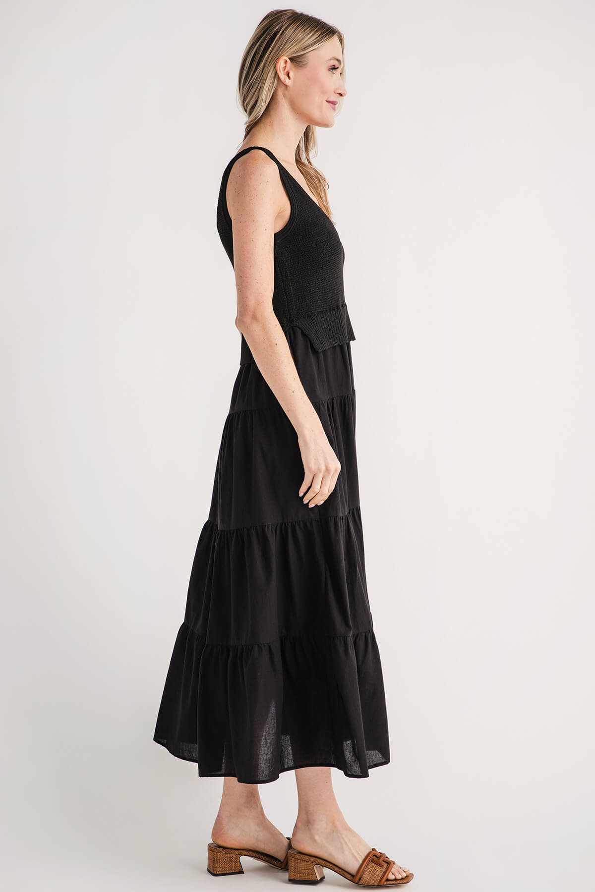 Black sleeveless tiered maxi dress, side view