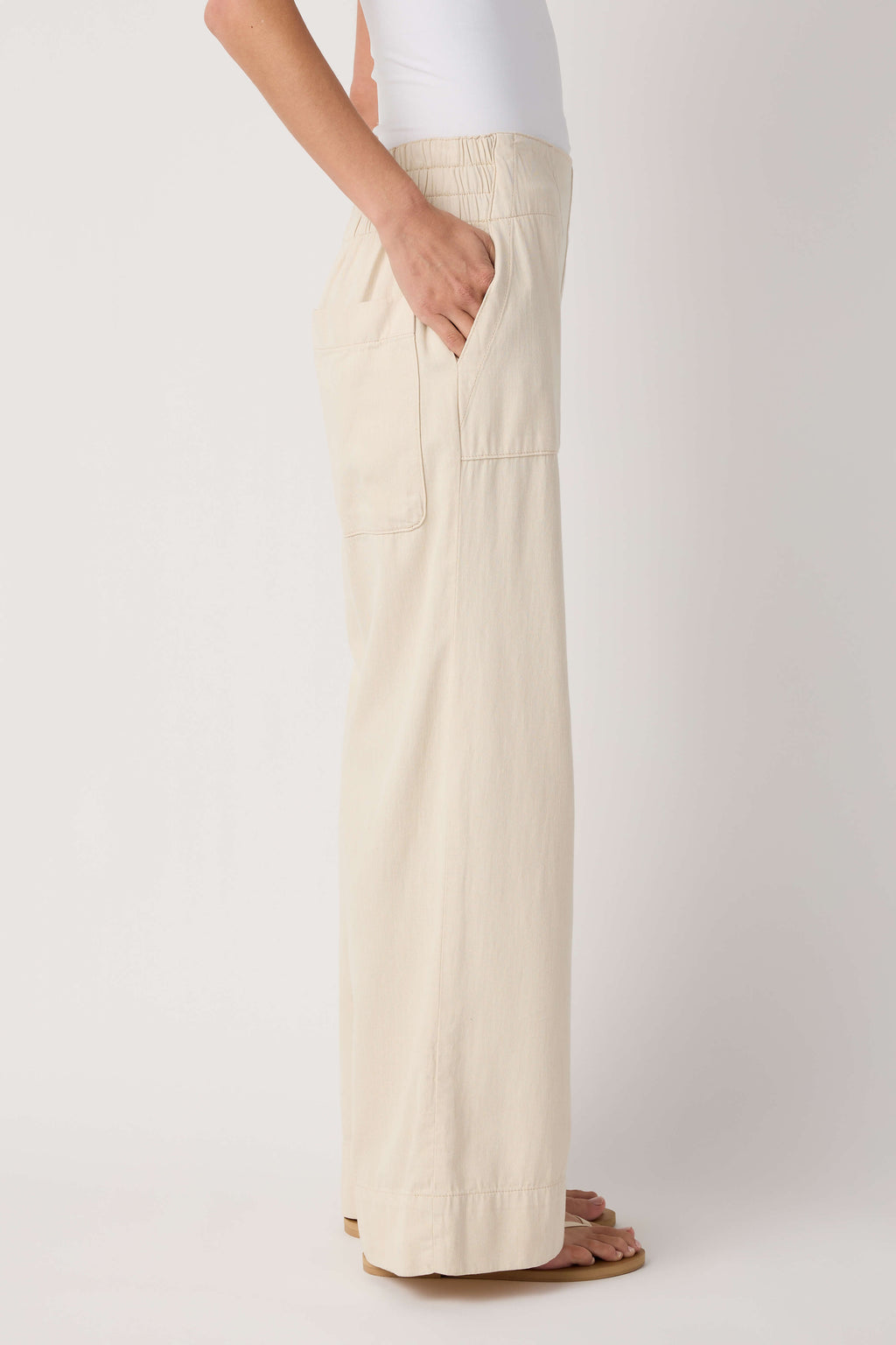Beige denim pull-on pants with side patch pocket and relaxed wide-leg fit