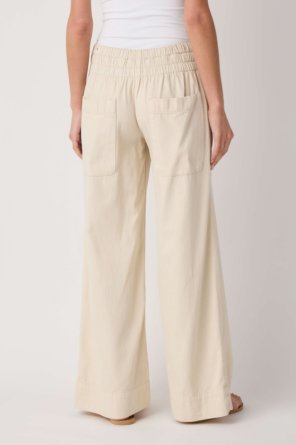 Beige denim pull-on pants with elastic waist and back patch pockets