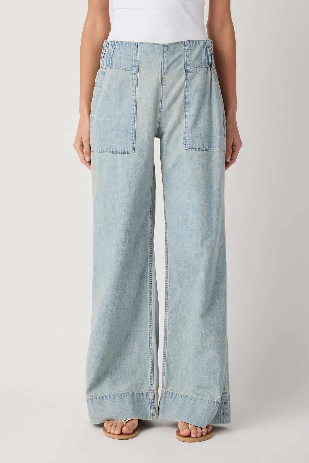 Light blue denim pull-on pants with front patch pockets and wide-leg hem