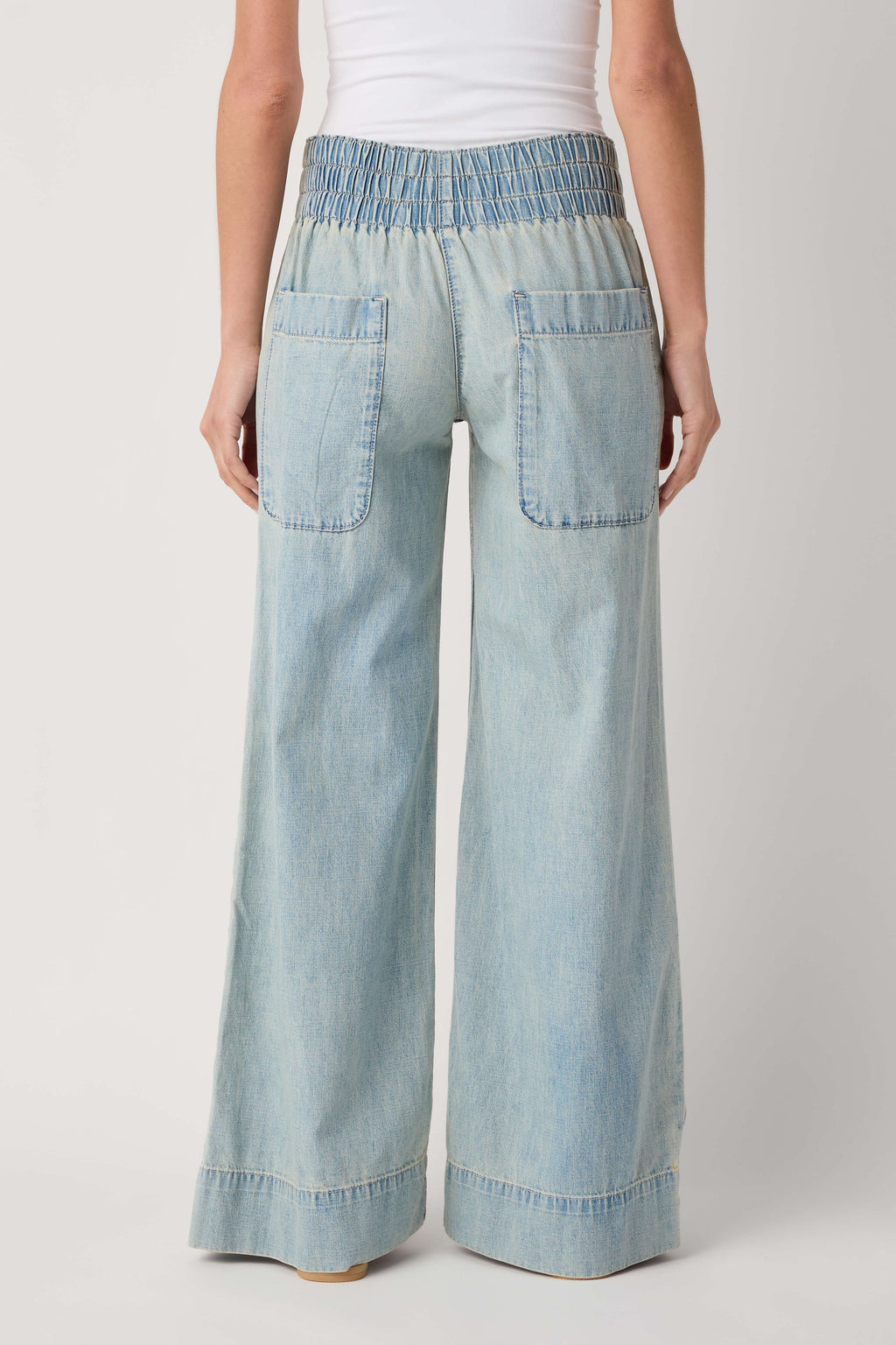 Light blue denim pull-on pants with gathered elastic waist and patch pockets