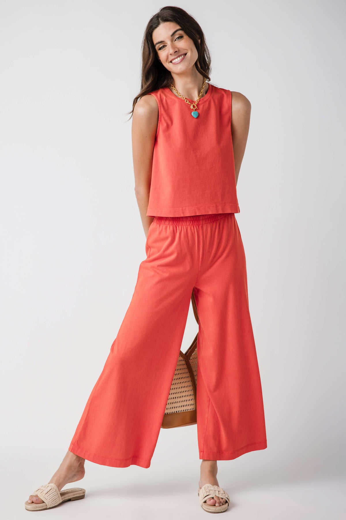 Jersey crop flare pants in coral orange, elastic waist, wide flared legs.