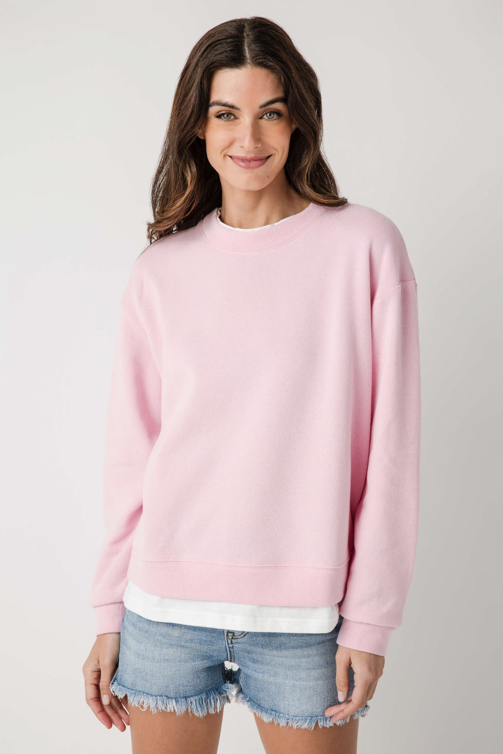 Pink crew pullover with crew neck, long sleeves, and ribbed hem