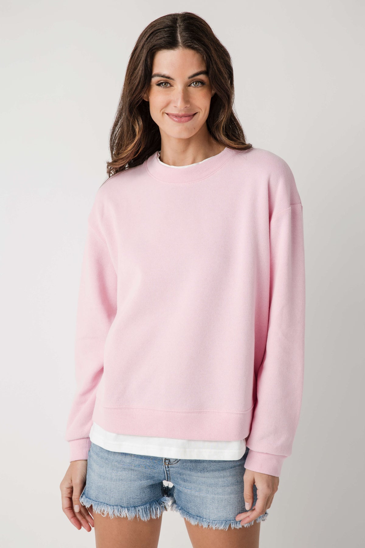 Pink crew pullover with crew neck, long sleeves, and ribbed hem