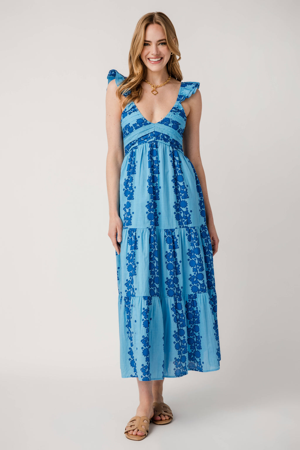 Blue V-neck tiered maxi dress with V neckline and layered floral tiered skirt