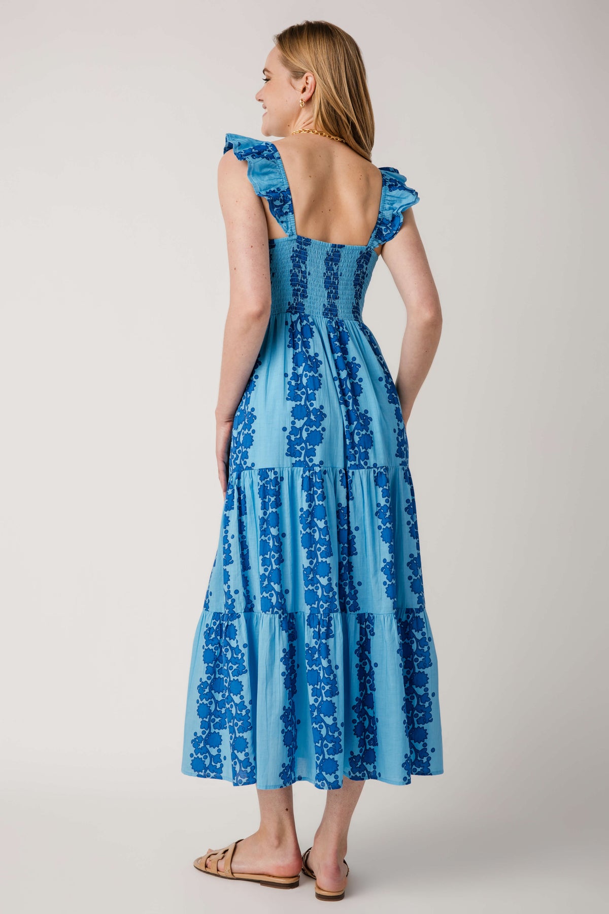 Blue tiered maxi dress with V-neck and low scoop back, ruffled shoulder straps