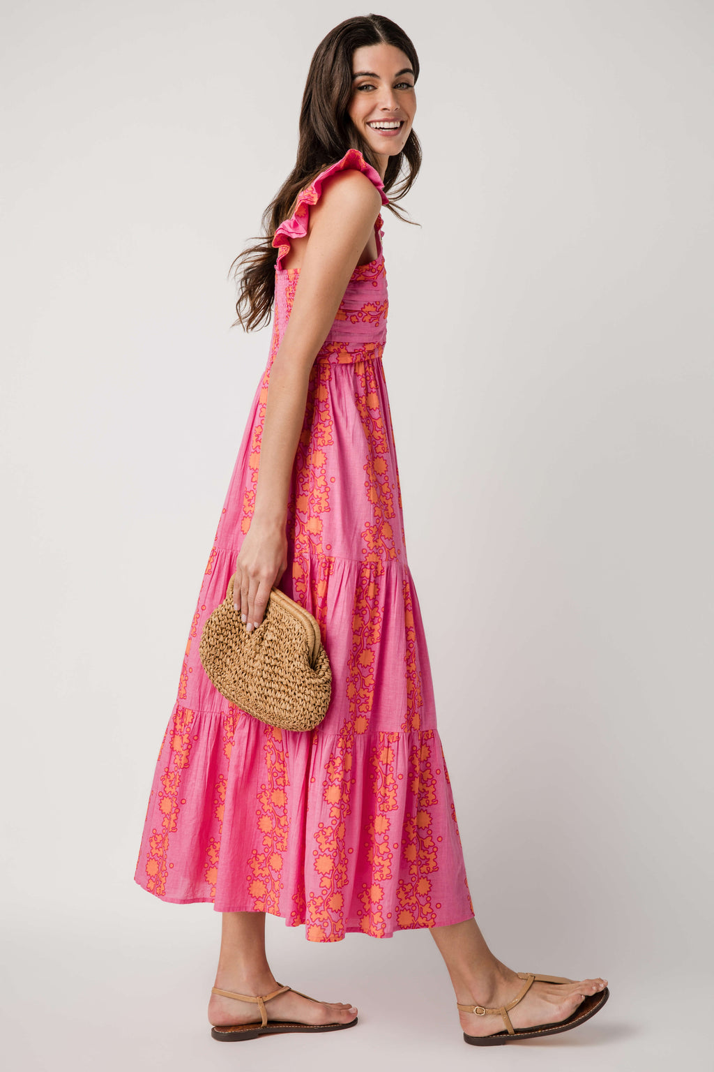 Pink V-neck tiered maxi dress with ruffled sleeves and golden floral pattern