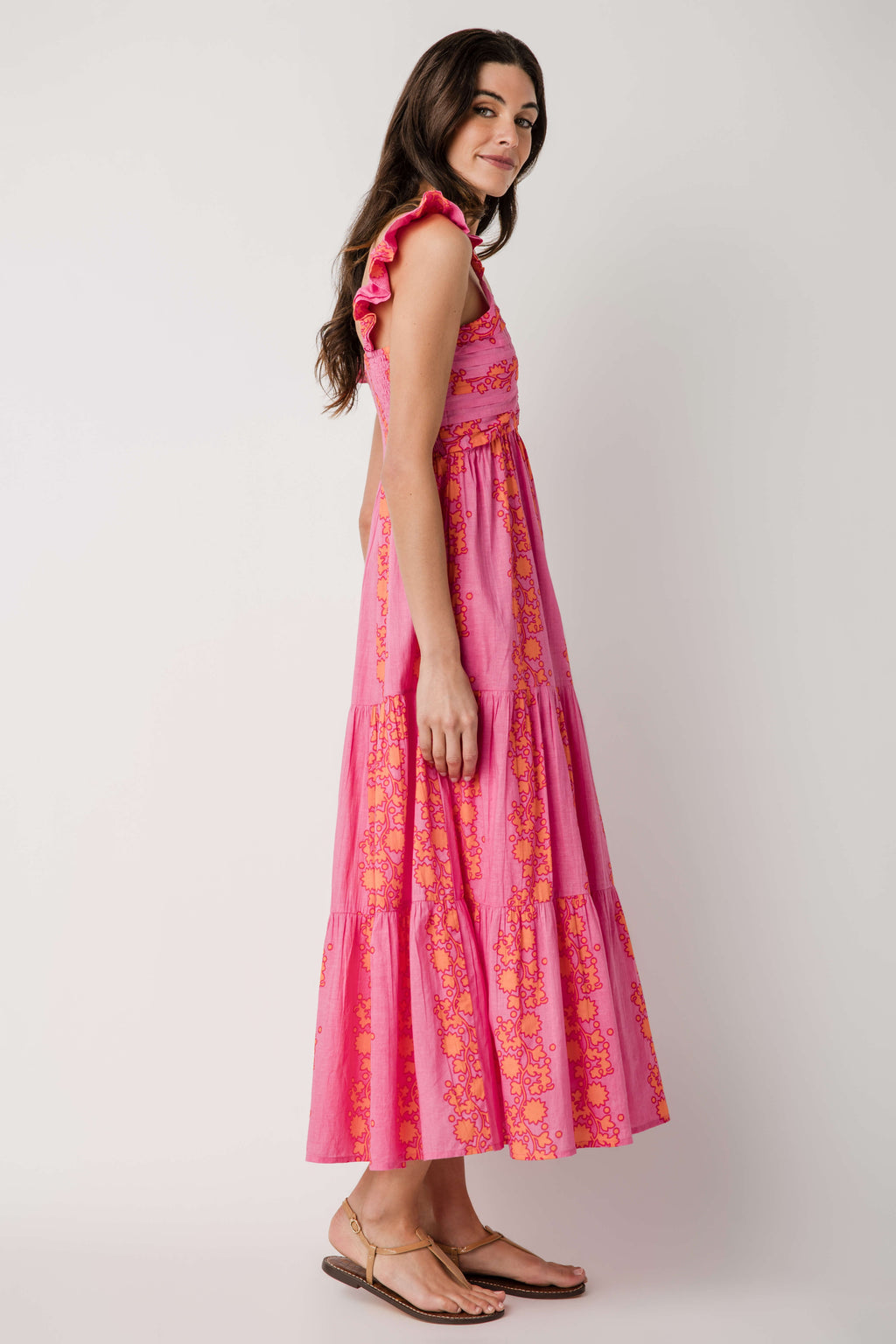 Pink V-neck tiered maxi dress with ruffled cap sleeves and allover golden floral design
