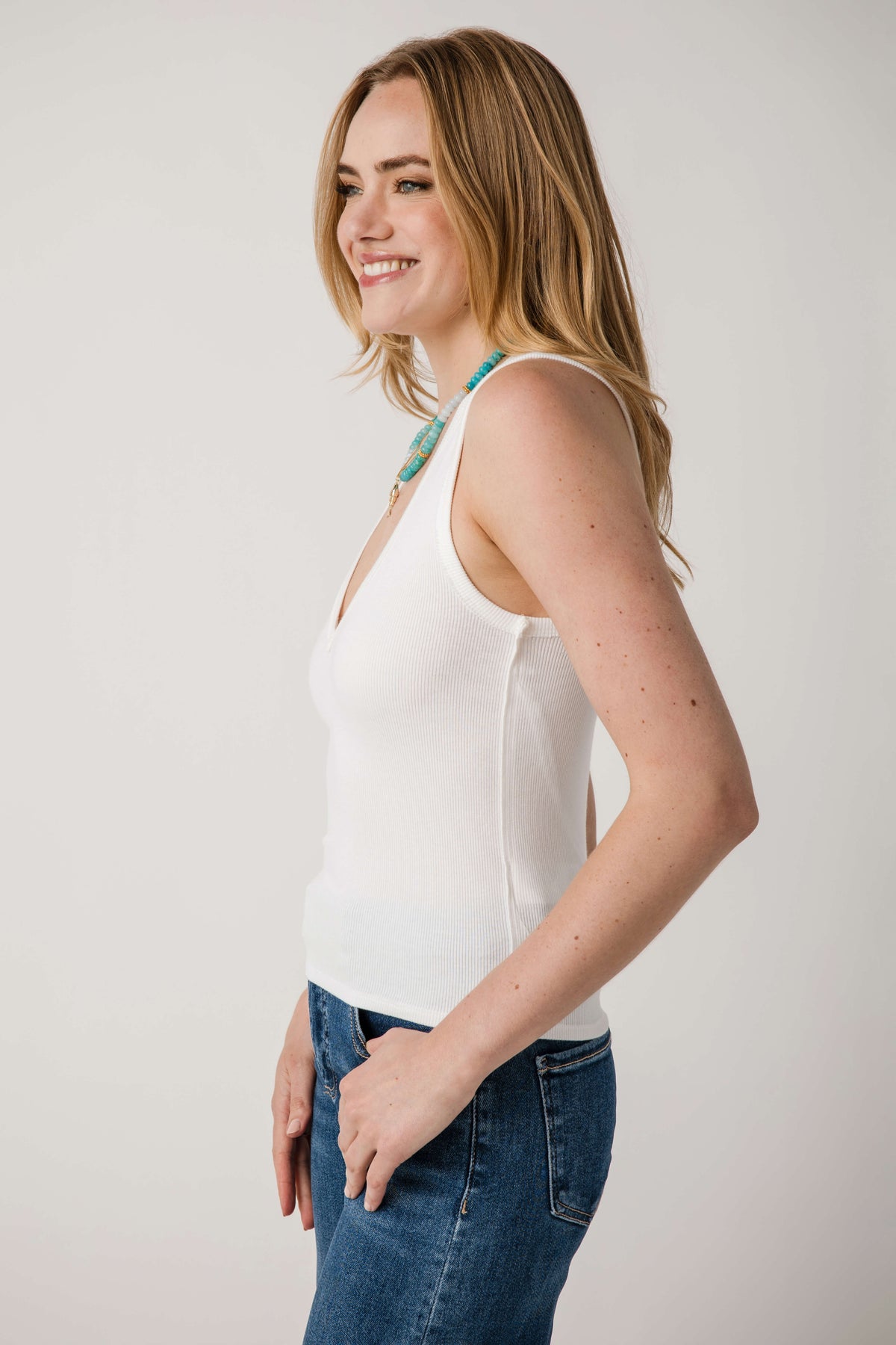 Ivory sleeveless tank top with V-neck and side seam shaping