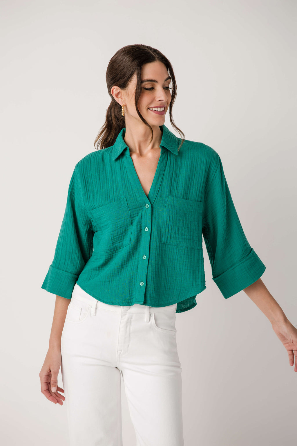 Rainforest green button-front shirt with chest pockets and elbow-length rolled sleeves