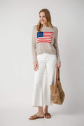 White mid-rise straight jeans with raw ankle hem, worn with sandals