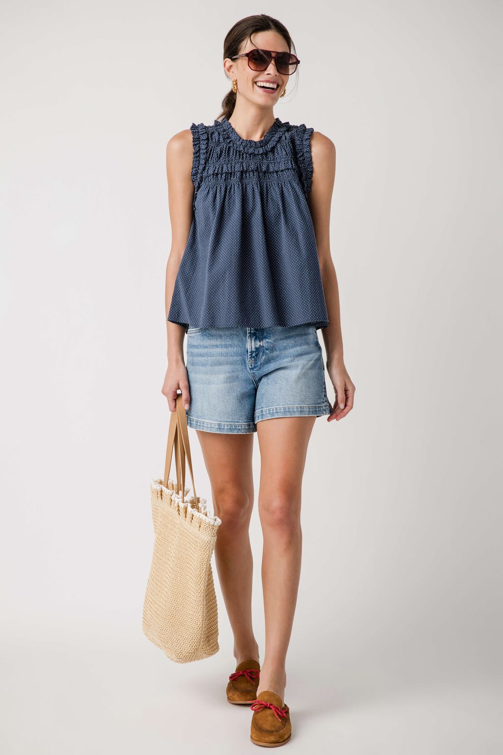 Navy sleeveless smocked birdseye top with high ruffle neckline