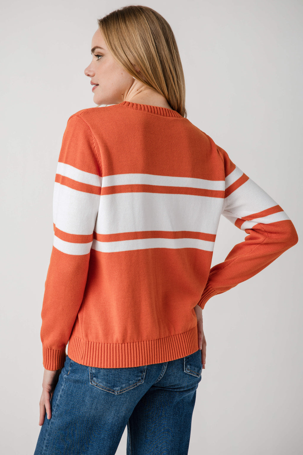 Orange vintage campus sweater with white horizontal stripes and ribbed cuffs