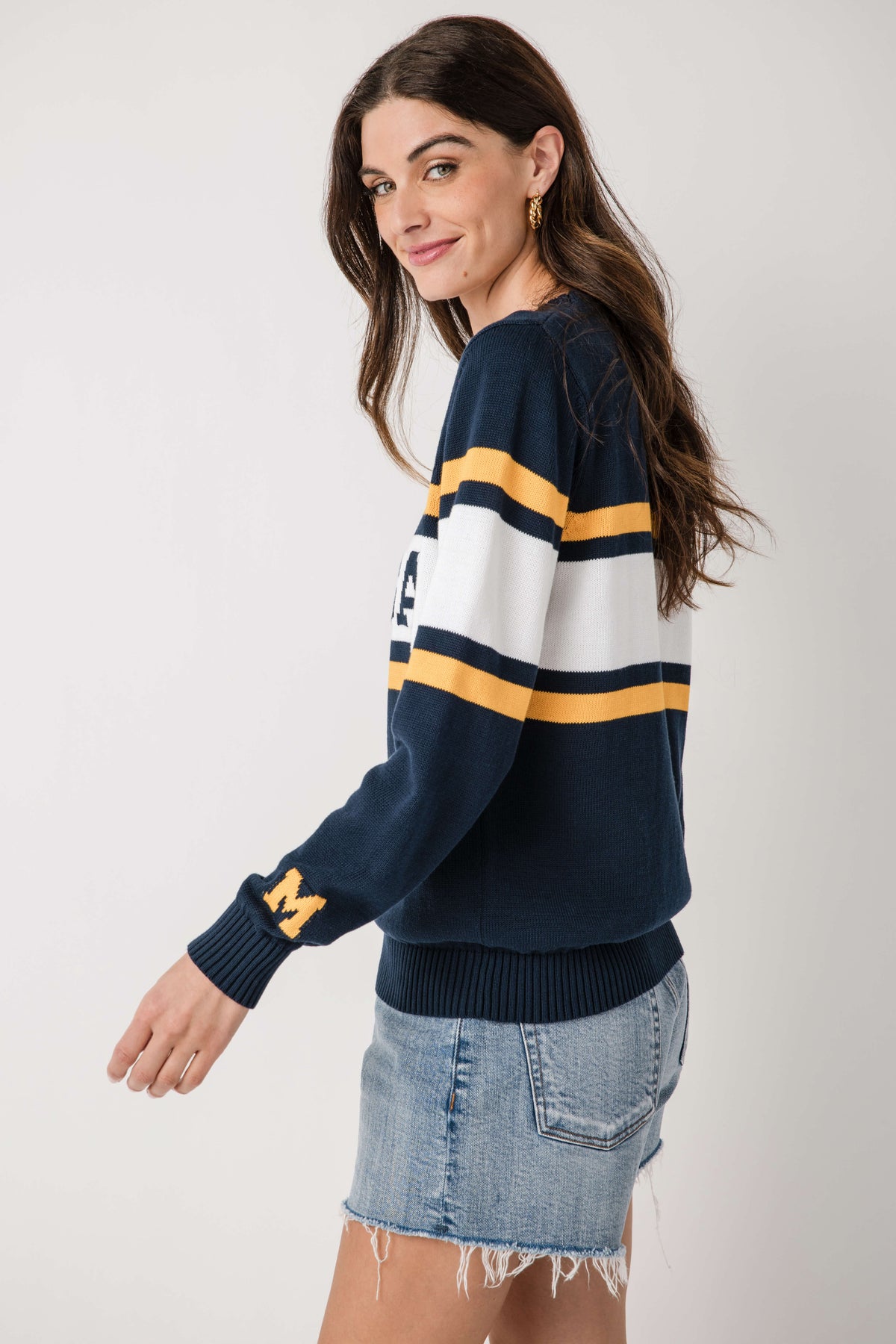 Navy vintage Michigan sweater with white-and-gold stripes and small chest emblem