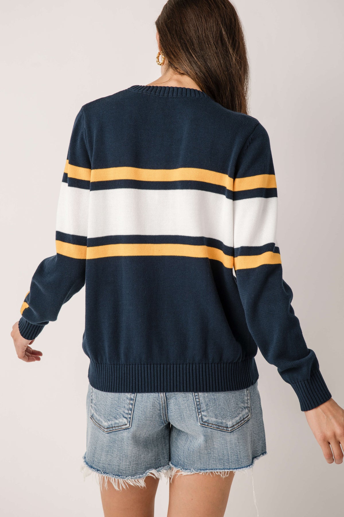 Back view of navy vintage Michigan sweater with wide white-and-gold stripe bands