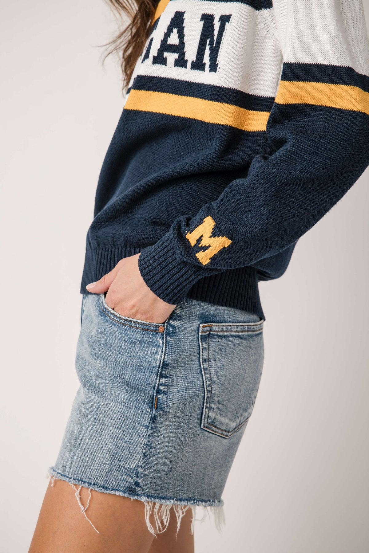 Close-up of navy Michigan sweater sleeve with small patch and ribbed cuffs