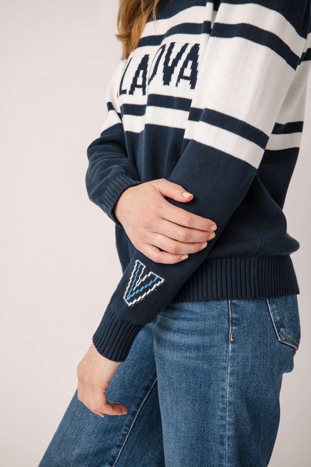 Close-up of navy Villanova sweater sleeve with white stripe and diamond patch