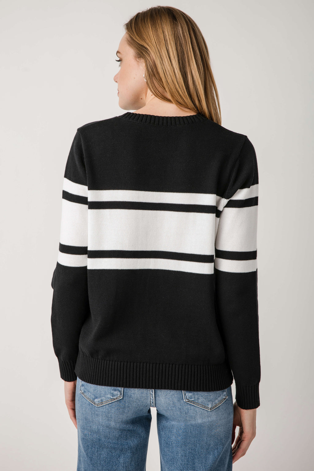 Black crewneck sweater with two horizontal white stripe bands on the back