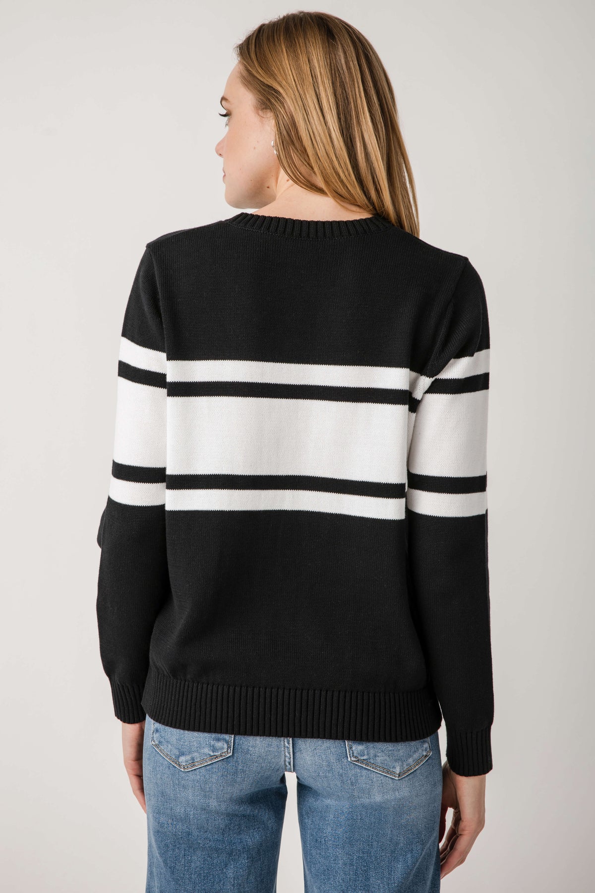 Black crewneck sweater with two horizontal white stripe bands on the back