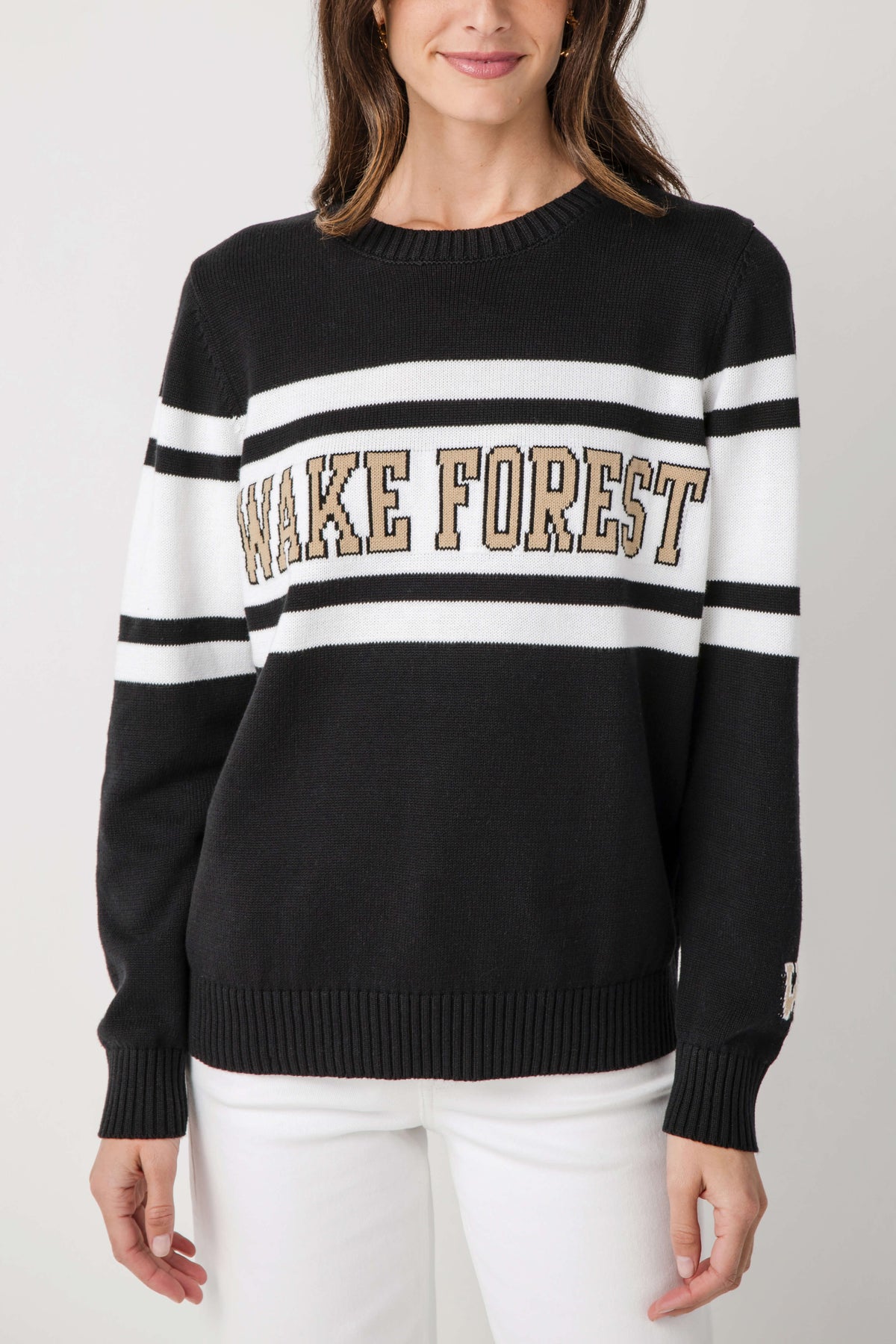 Black crewneck sweater with wide white stripes and Wake Forest logo on the front