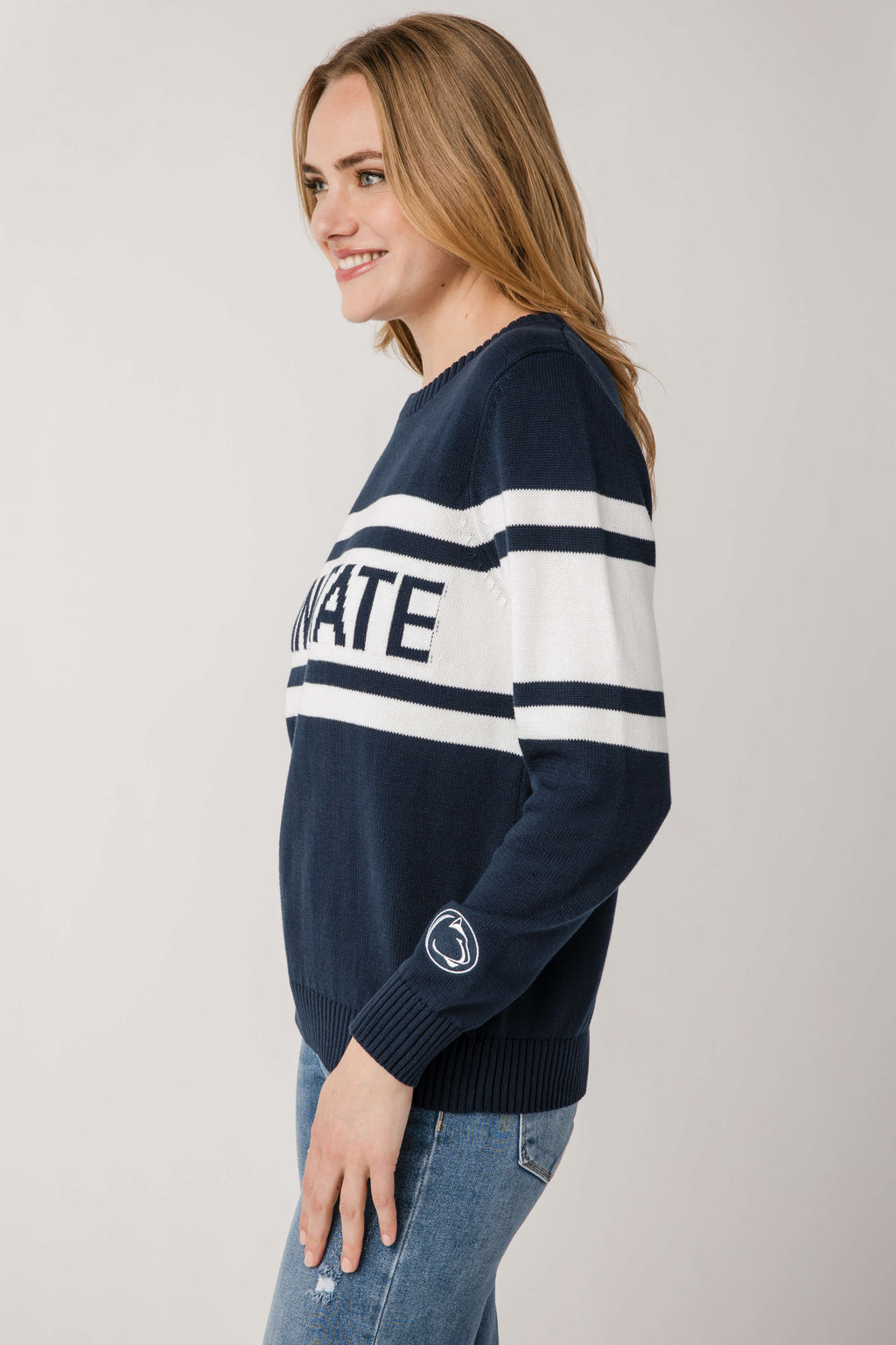 Vintage campus sweater in dark navy with white stripe bands and partial Penn State logo