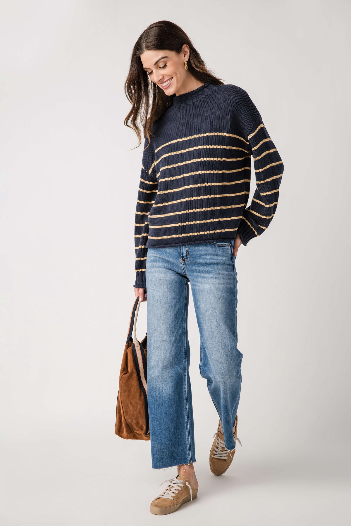 Navy mockneck knit sweater with gold and cream striped bands, long sleeves and ribbed hem.