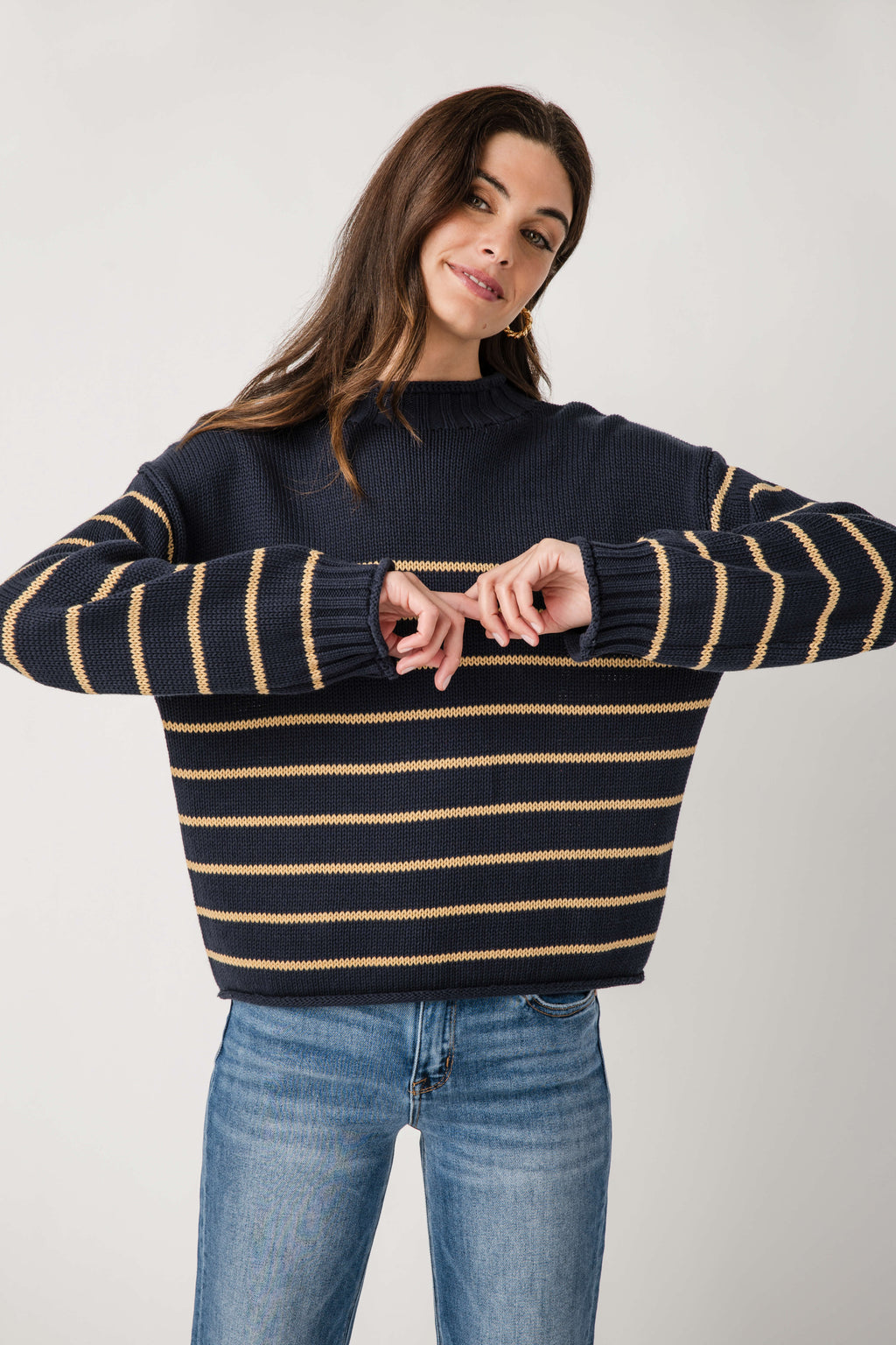 Navy striped mockneck knit sweater with gold and cream horizontal lines, crew-like collar.