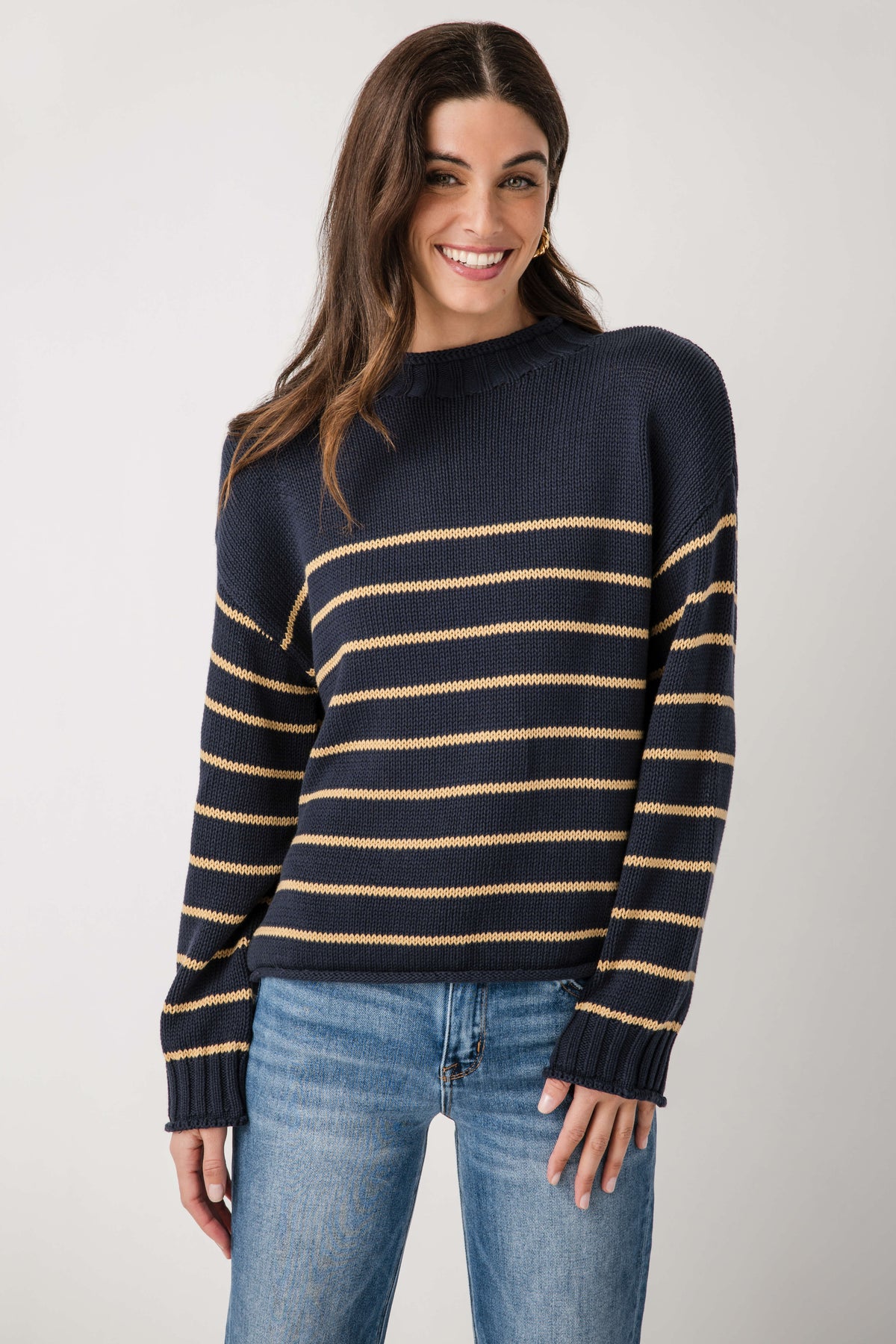 Navy knit mockneck sweater with gold and cream horizontal stripes, ribbed collar and cuffs.