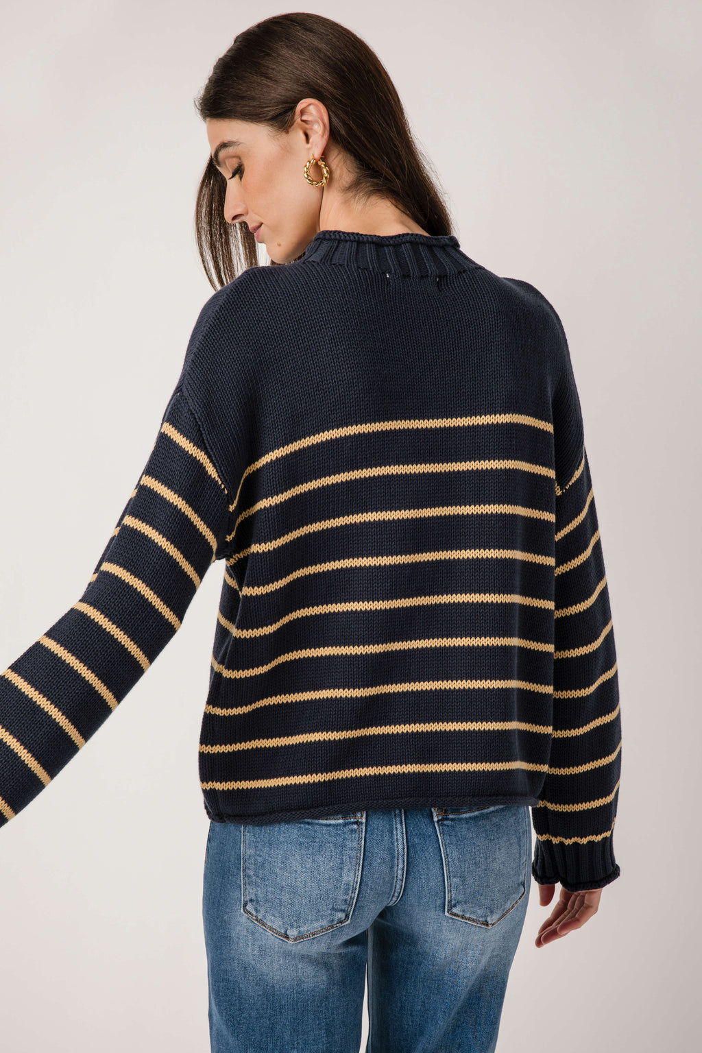 Navy striped knit mockneck sweater, angled back view with banded cuffs
