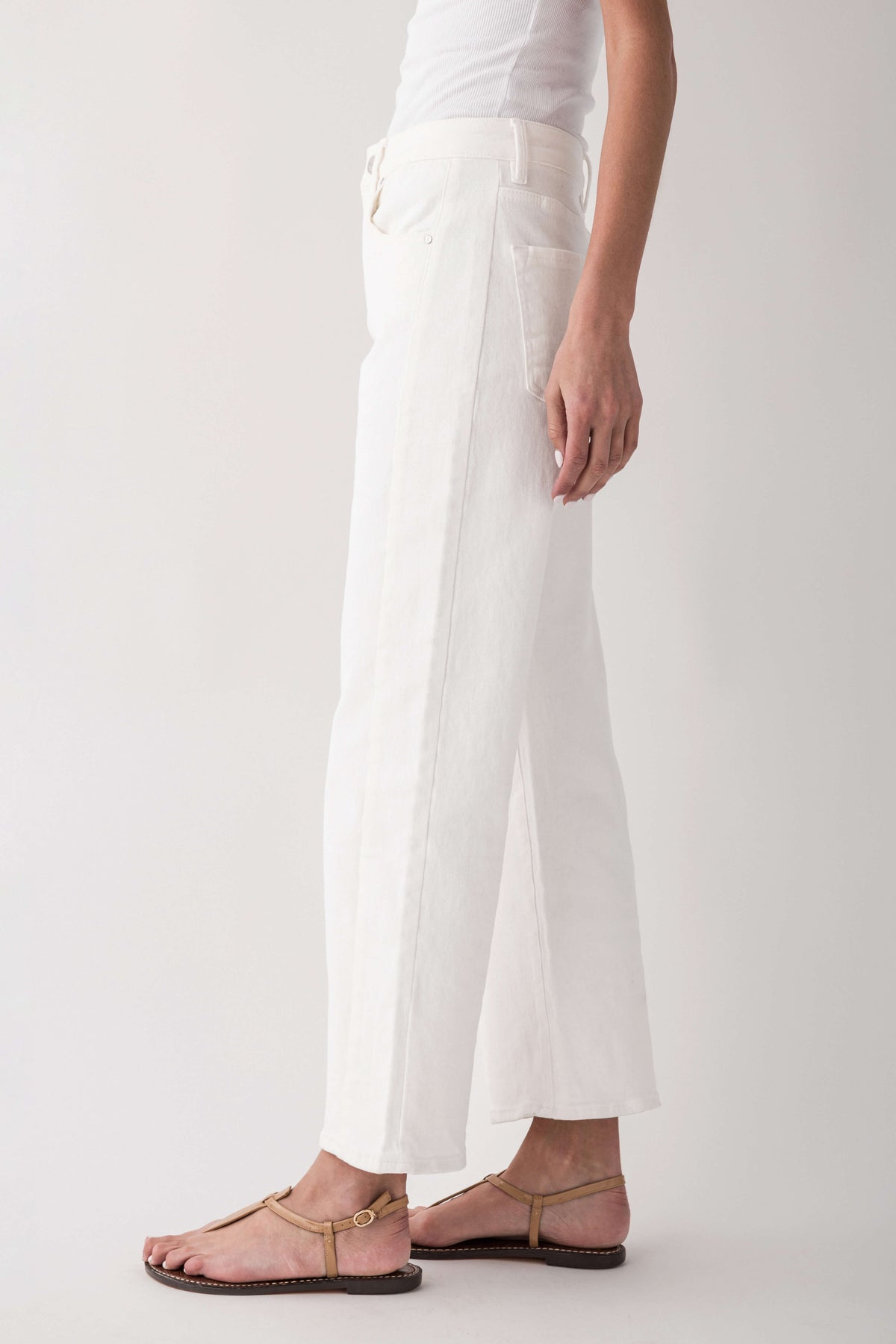 High-rise cream jeans, side view of relaxed wide leg with belt loops