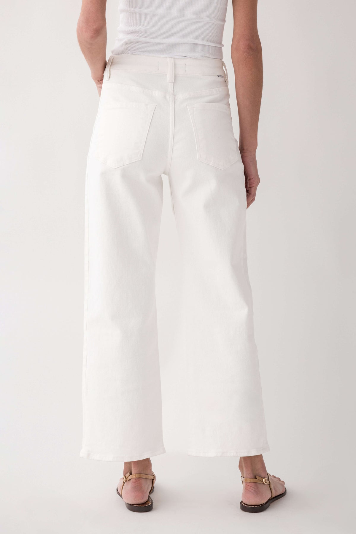 High-rise cream jeans, back view with wide cropped leg and belt loops