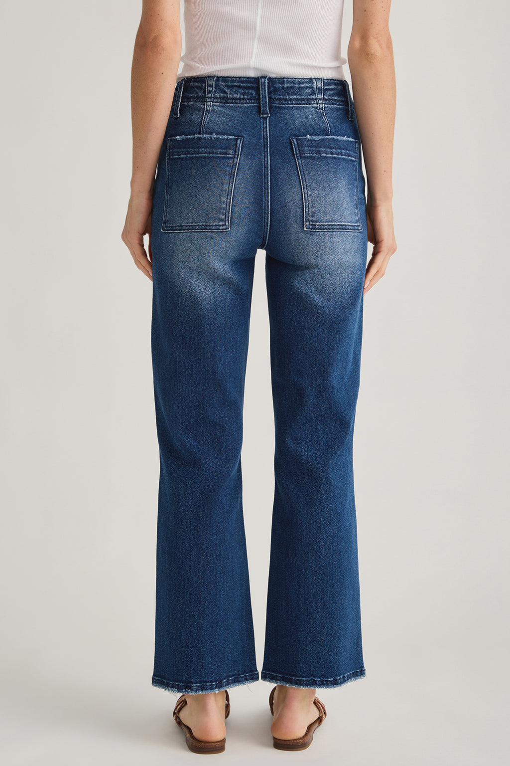 Front view ankle flare jeans in dark blue with belt loops and clean whisker details