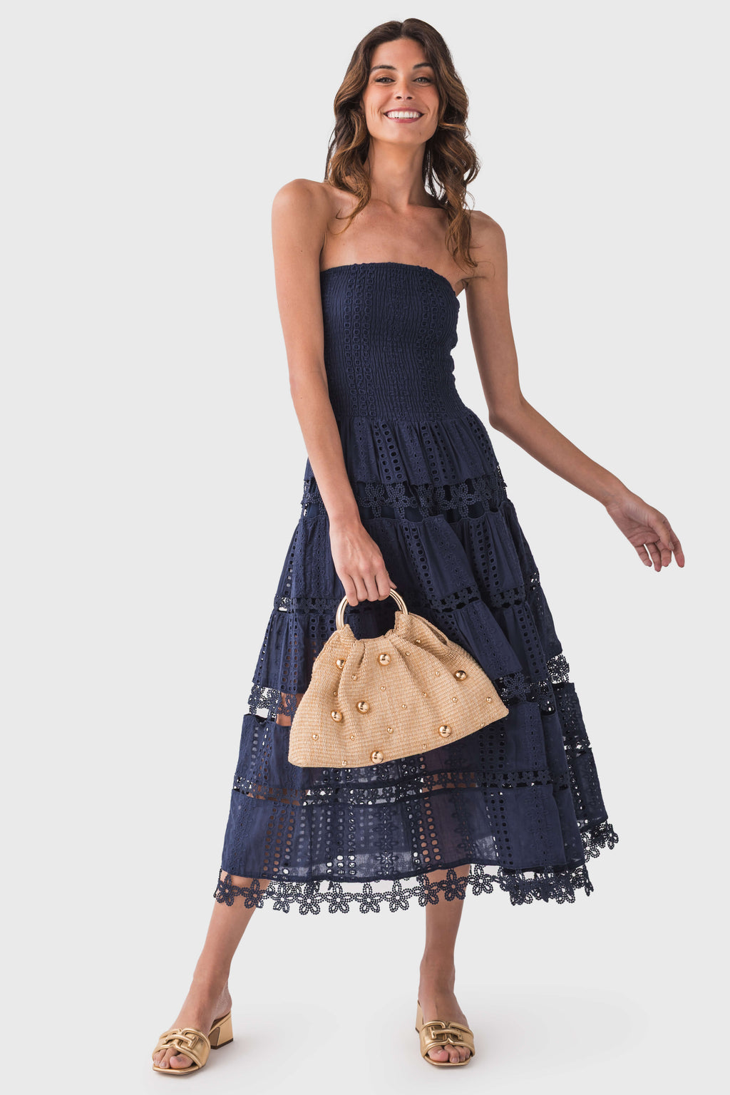 Navy strapless eyelet lace tube dress with tiered skirt and lace trim hem