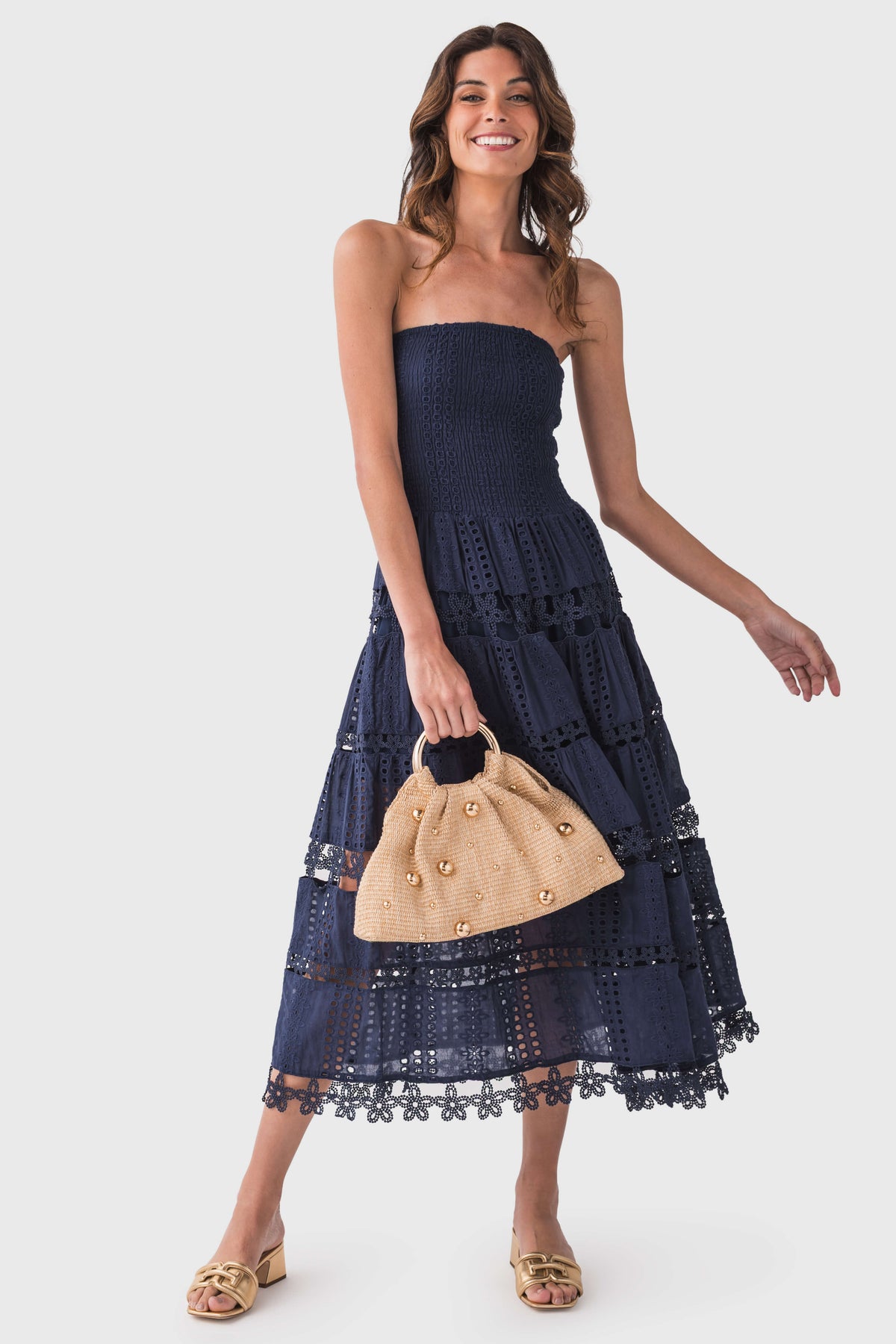 Navy strapless eyelet lace tube dress with tiered skirt and lace trim hem