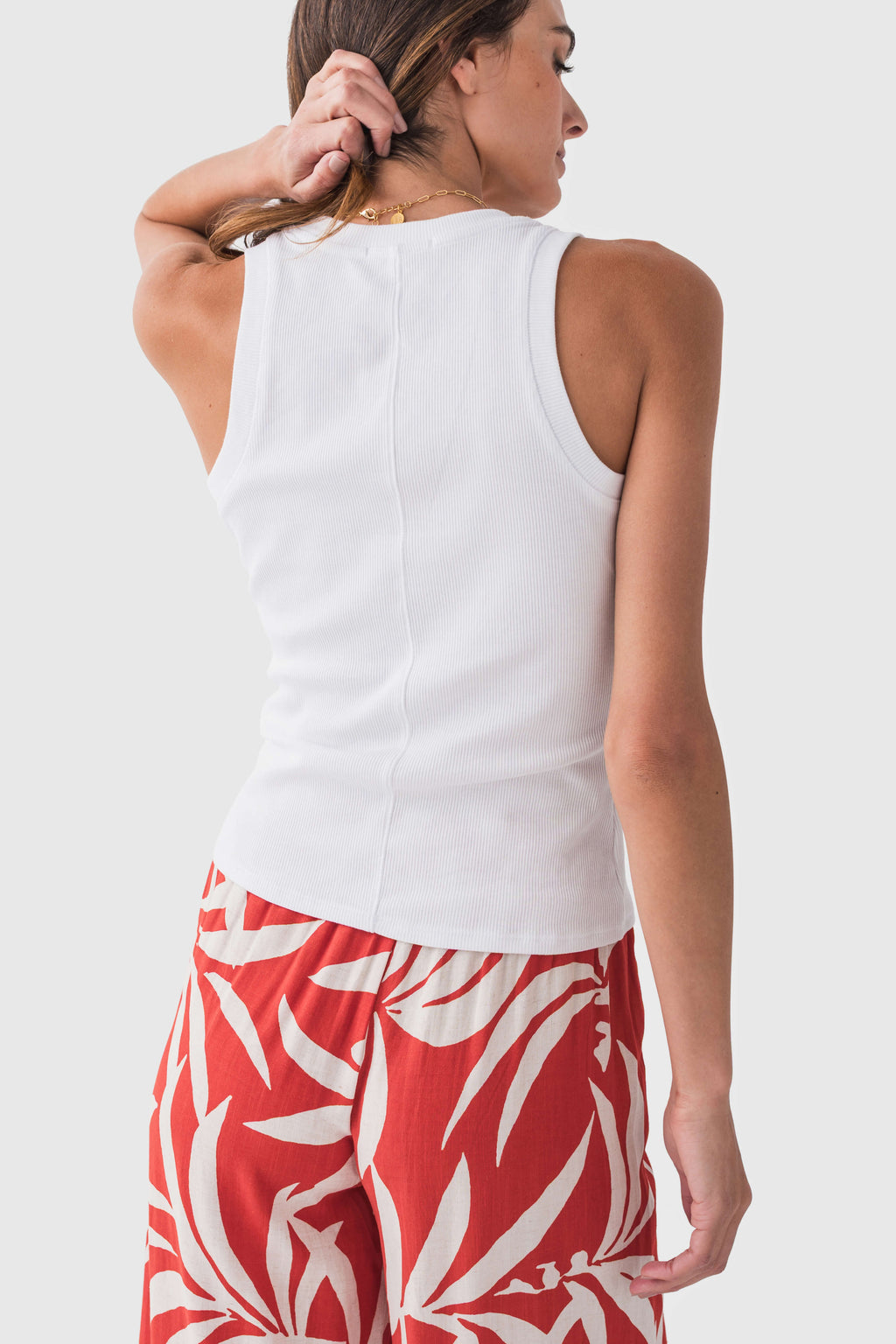 White ribbed sleeveless tank top with scoop neck, visible side seam