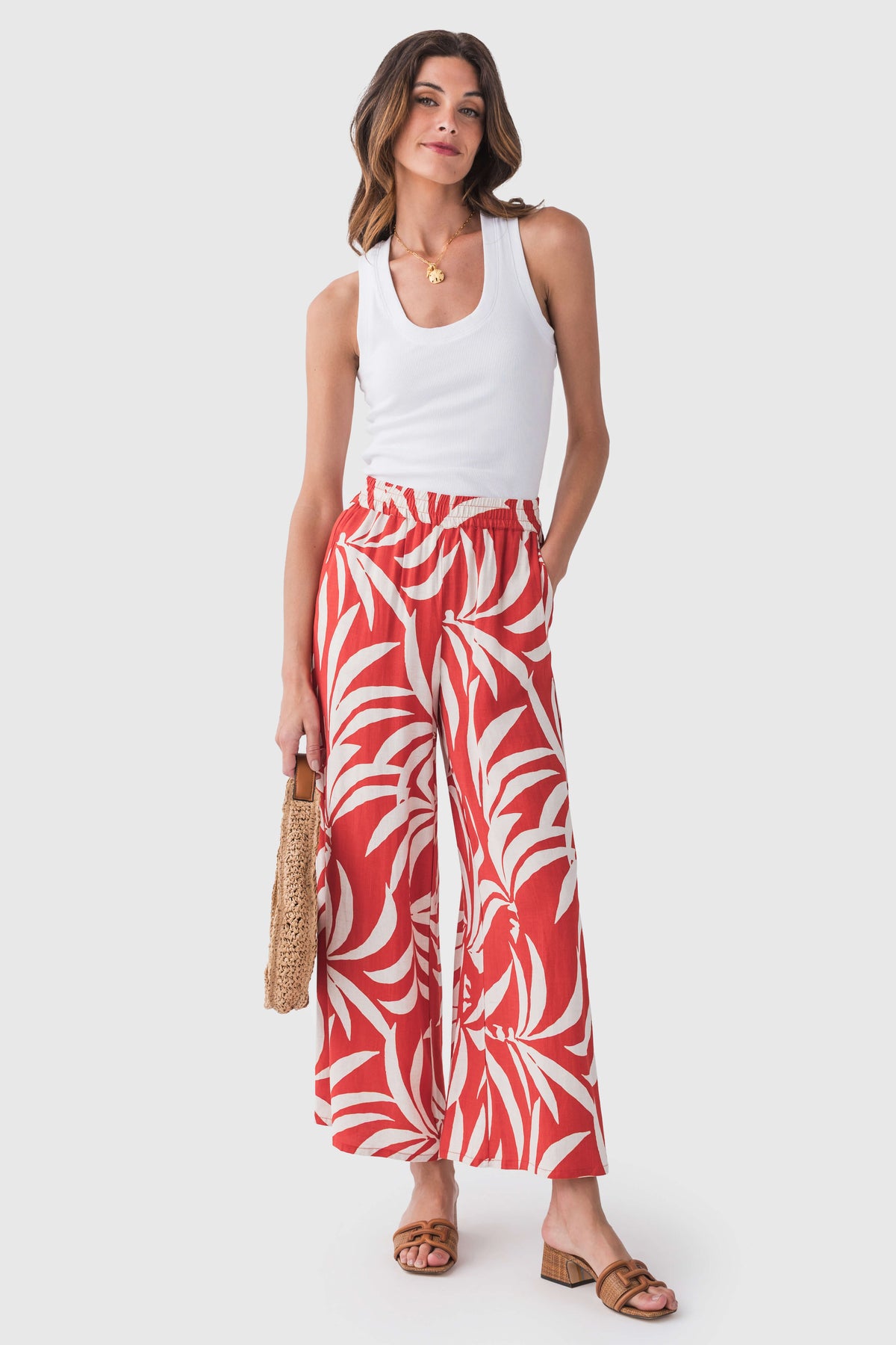 White ribbed sleeveless tank top with scoop neck and fitted silhouette