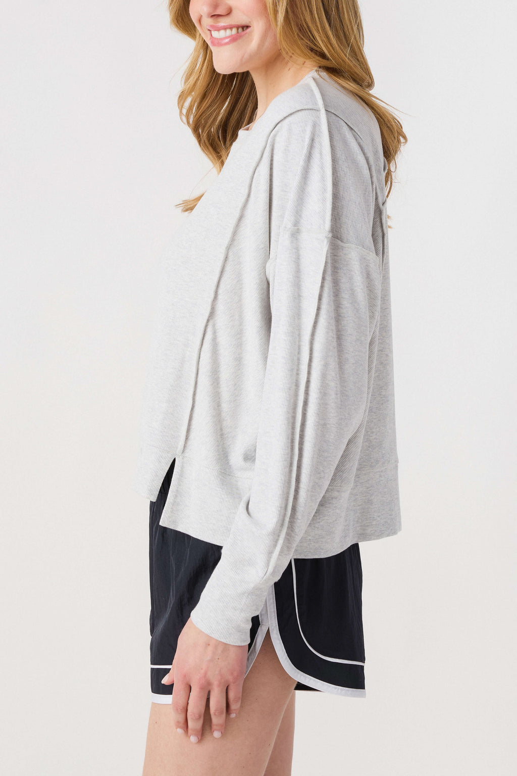 Heather grey long-sleeve tee shown in side profile with side slit