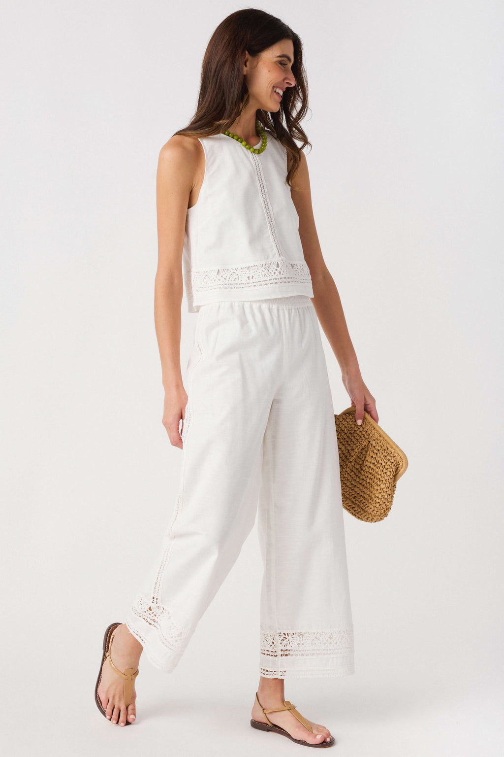 White embroidered wide-leg pants with lace-trim hem and vertical embroidered side panel
