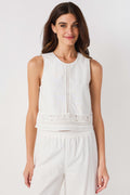 White sleeveless embroidered top with rounded neckline and lace-trim hem
