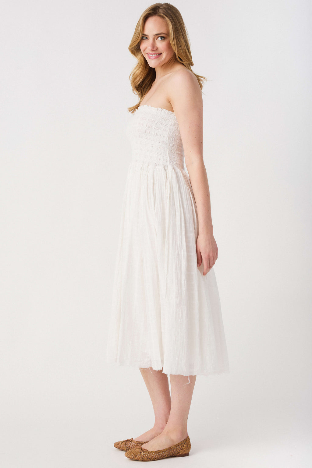 Ivory strapless maxi skirt with textured smocked bodice and tiered skirt layers