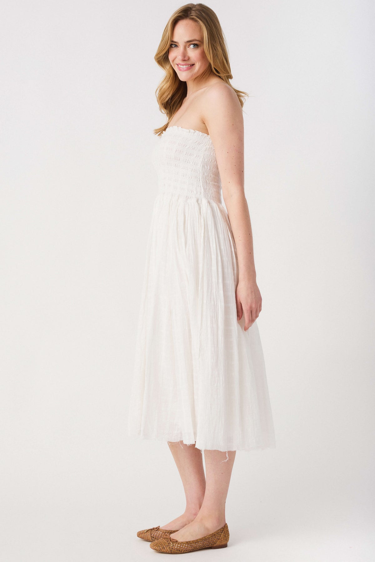 Ivory strapless maxi skirt with textured smocked bodice and tiered skirt layers