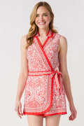 Red and white printed sleeveless romper, front close-up, tied waist and V-neck