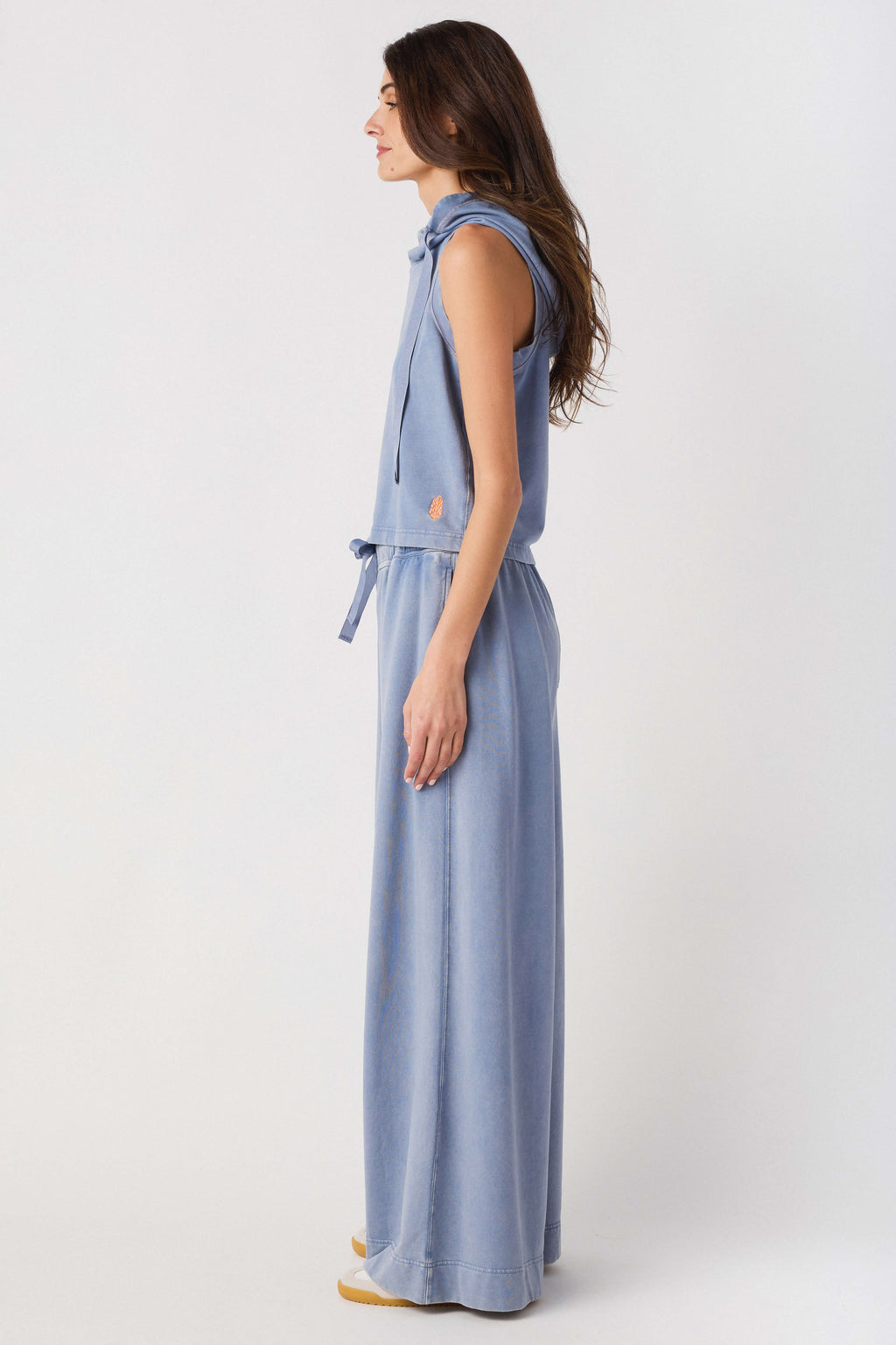 Light blue sleeveless hoodie top and wide-leg pants set, side profile view