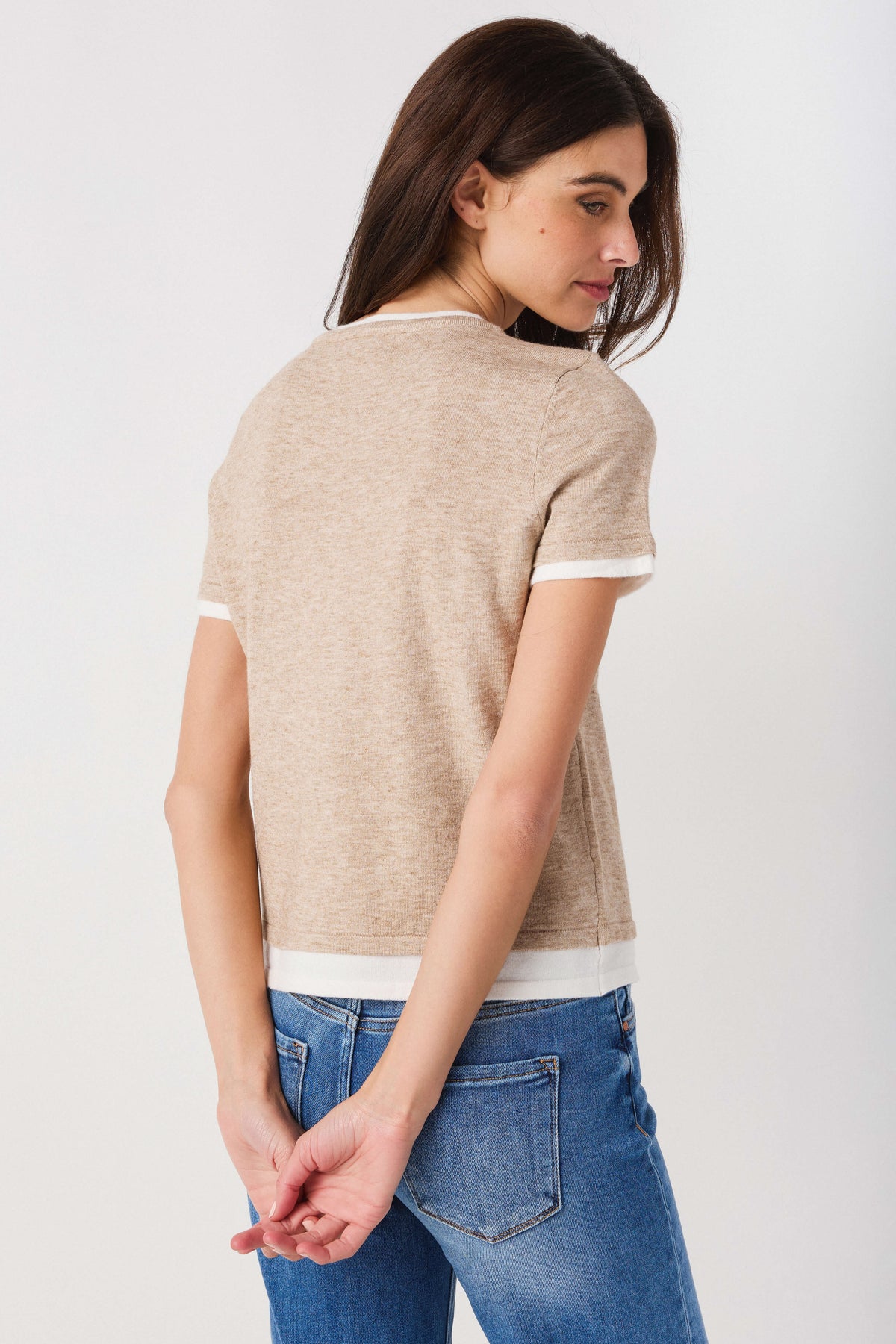 Taupe double-layer knit top with white trim, short sleeves and rounded crew neck, back view.