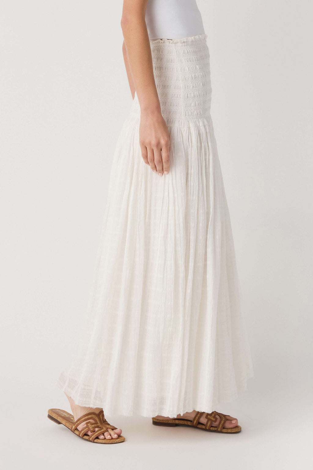 Ivory tiered maxi skirt with elastic smocked waist and gathered pleats, side view