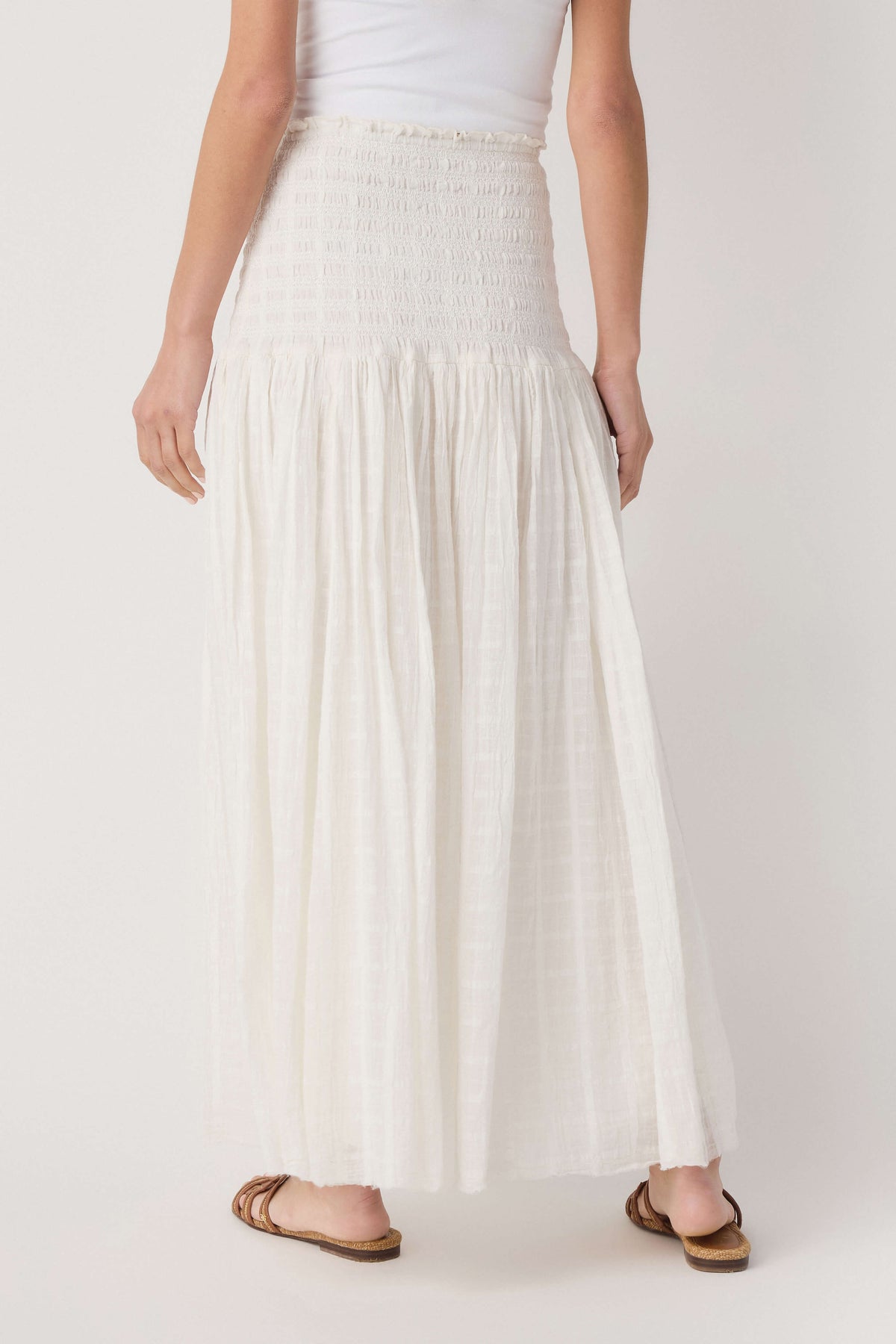 Ivory tiered maxi skirt with smocked waistband and sheer, flowy fabric
