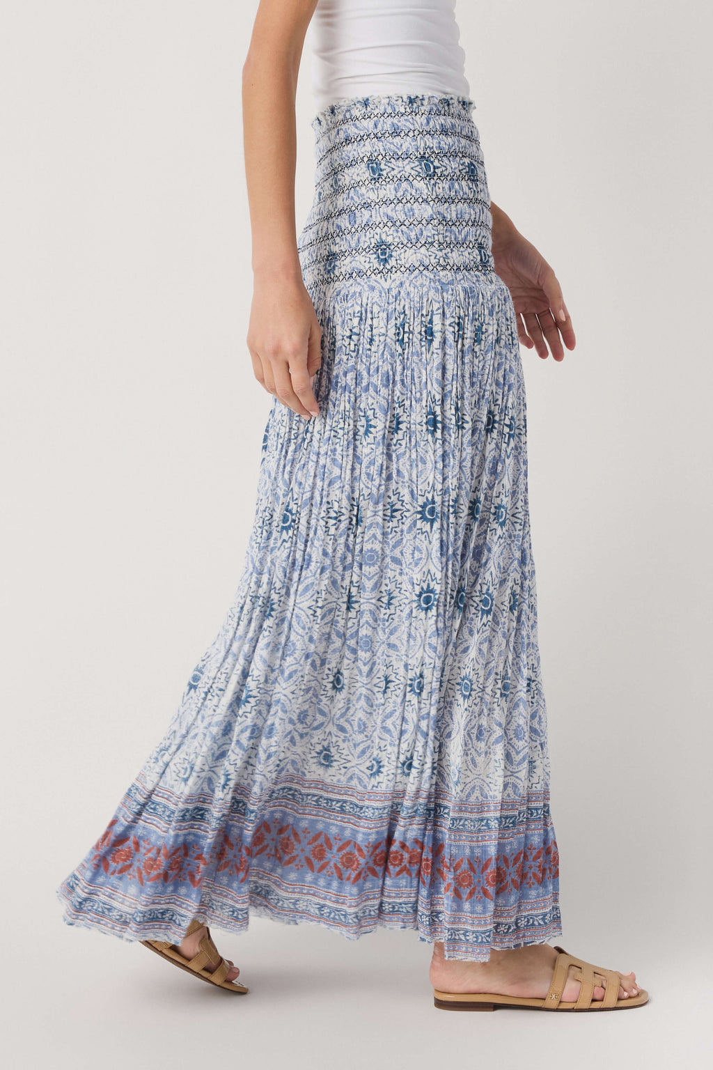 Blue-and-white patterned tiered maxi skirt with smocked waistband and ruffle hem