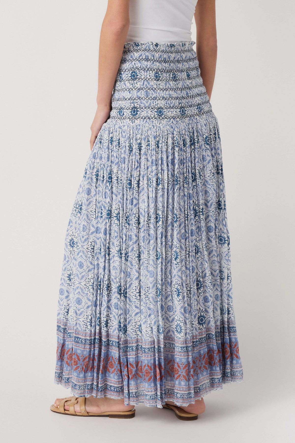 Blue patterned tiered maxi skirt with smocked waist and multicolor border at hem